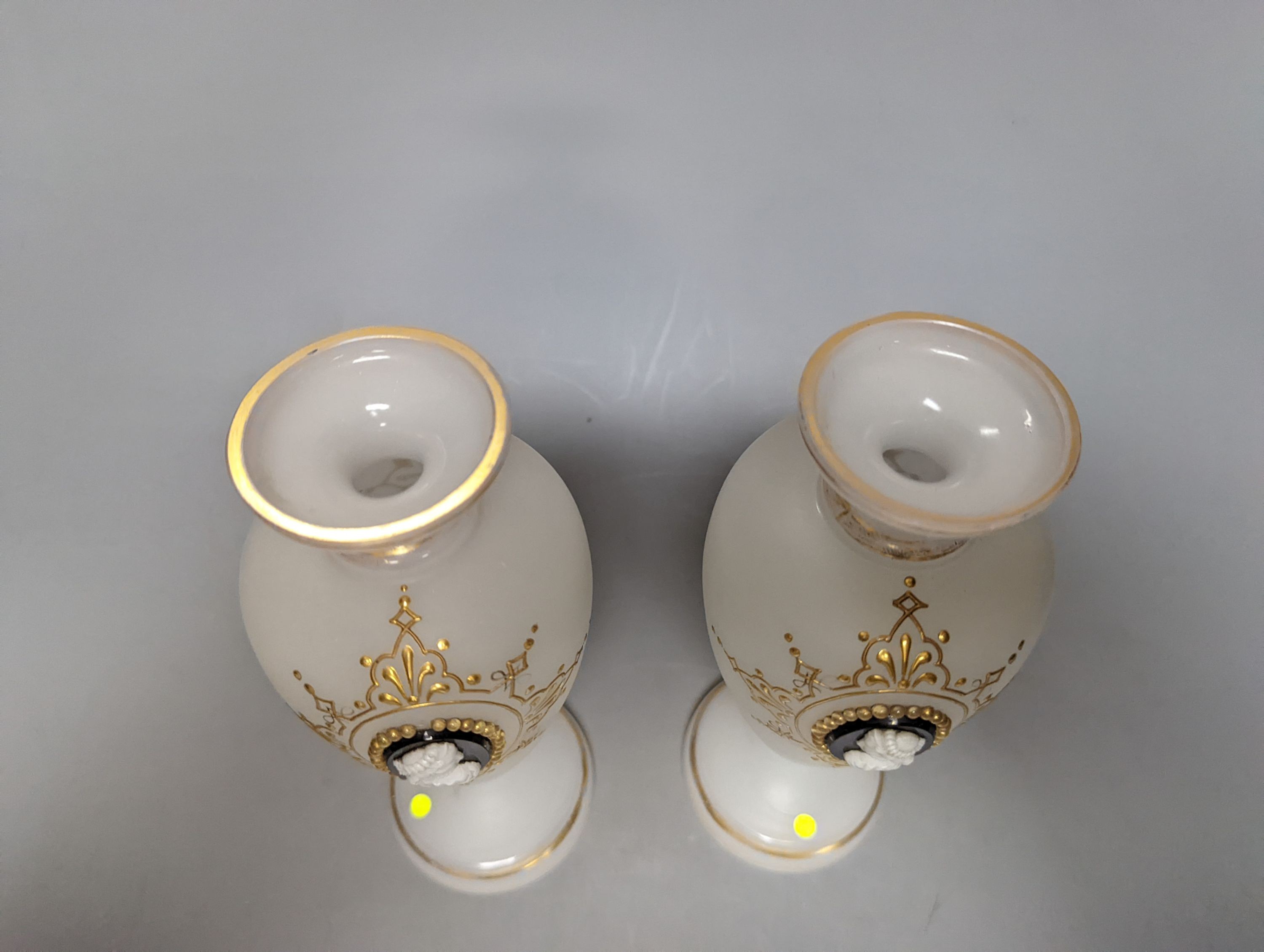 Two cameo and gilt decorated vases, 23 cms high.